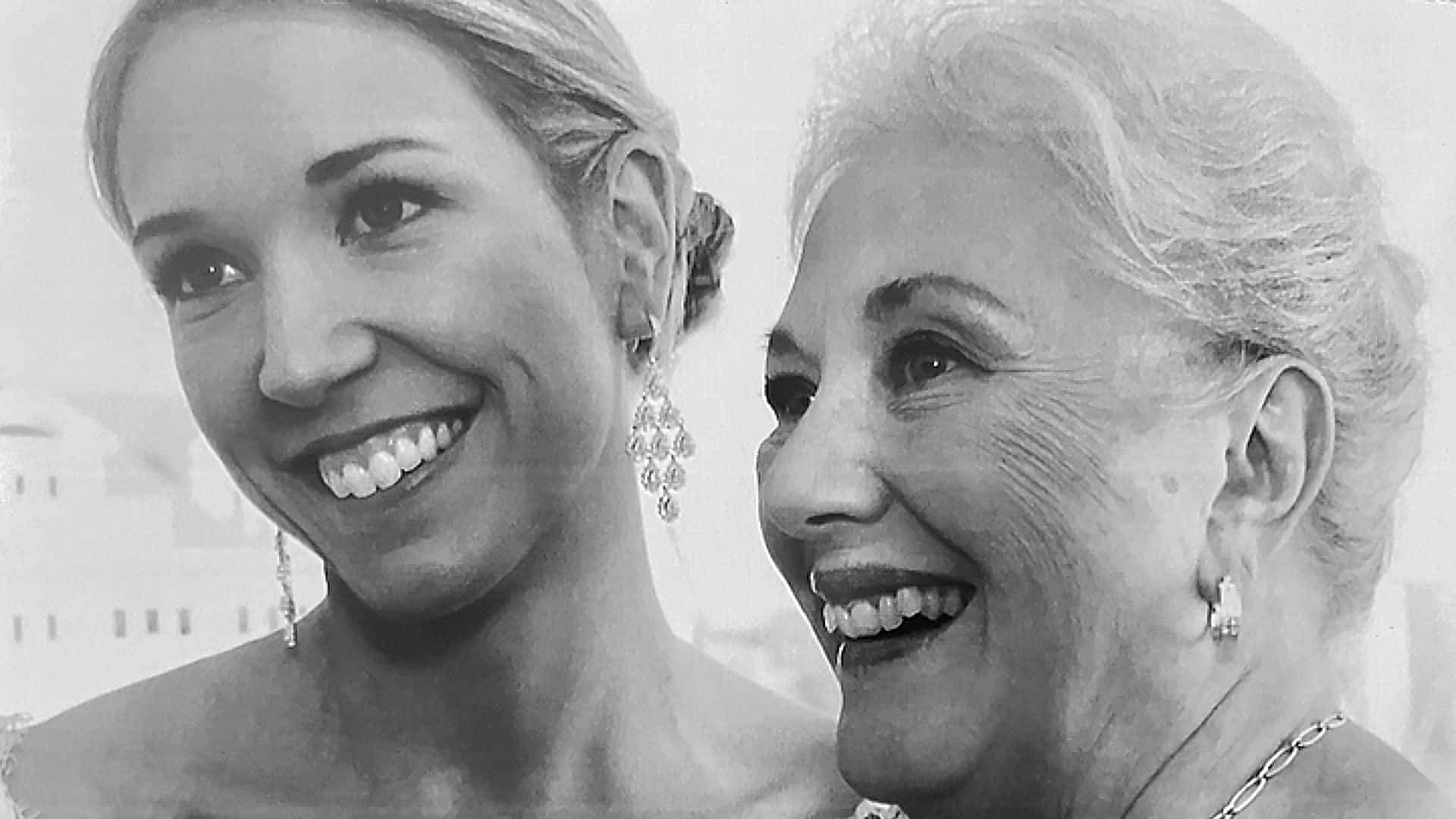 A black and white photograph of two women with their hair up, one younger and one older